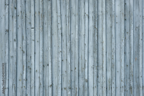 background of gray painted wooden boards. wooden fence with narrow slats. embossed background of wooden boards gray blue texture.
