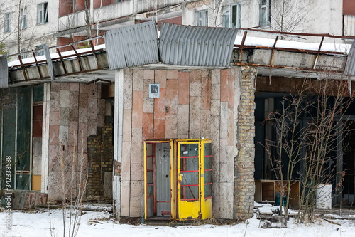 Old soviet yellow telephone booth in ghost town Prypiat. Pripyat, Chornobyl exclusion zone. December 2016 photo