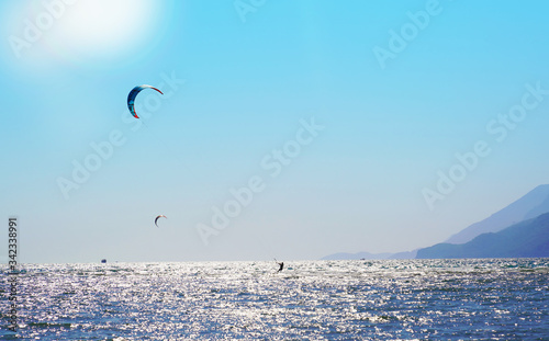 Akyaka, Mugla/Turkey-August 14 2018: A female surfer enjoying kite surfing at the beach where Azmak River meets the Mediterranean Sea photo