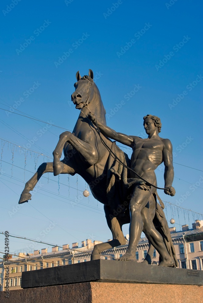 Fototapeta premium Horse tamers monument by Peter Klodt on Anichkov Bridge in Saint-Petersburg Russia. 