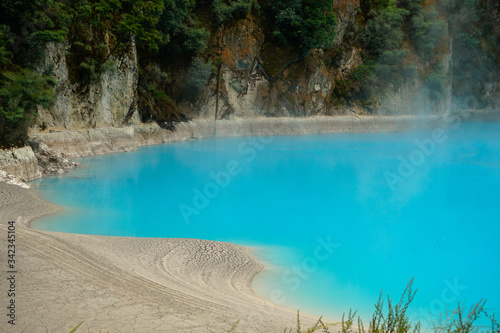 WAIMANGU VOLCANIC VALLEY, NEW ZEALAND - MARCH 03, 2020: Light blue geothermal lake in the Inferno crater 