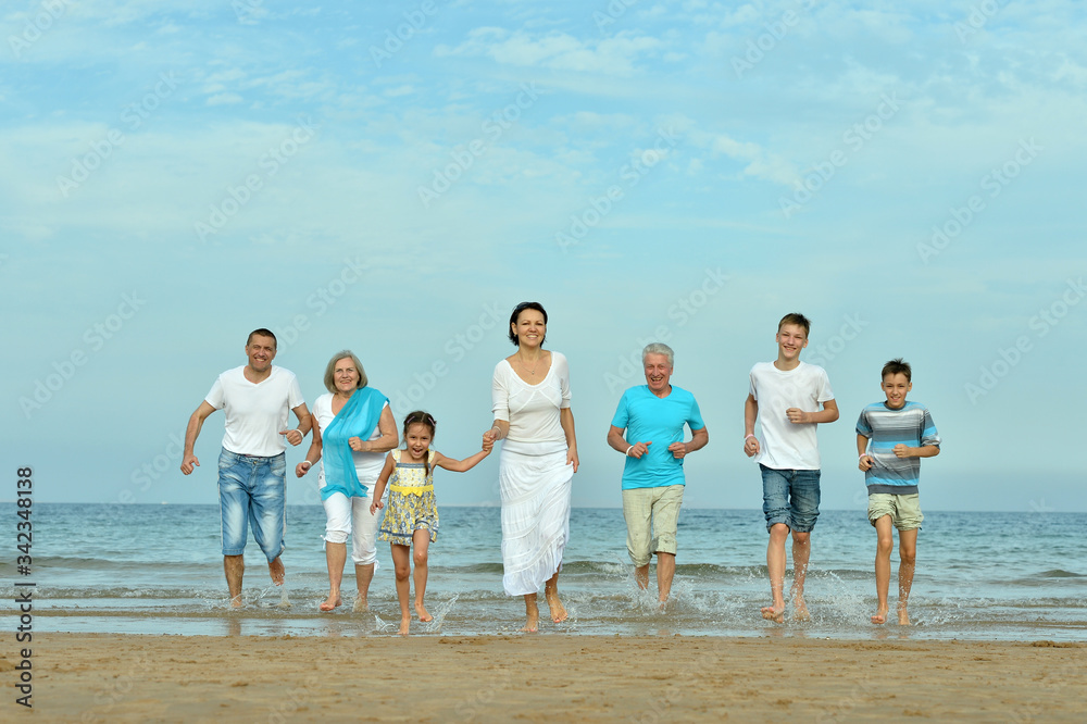 Happy family sitting at beach in summer