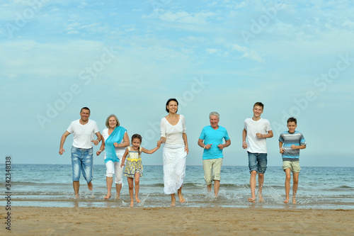 Happy family sitting at beach in summer