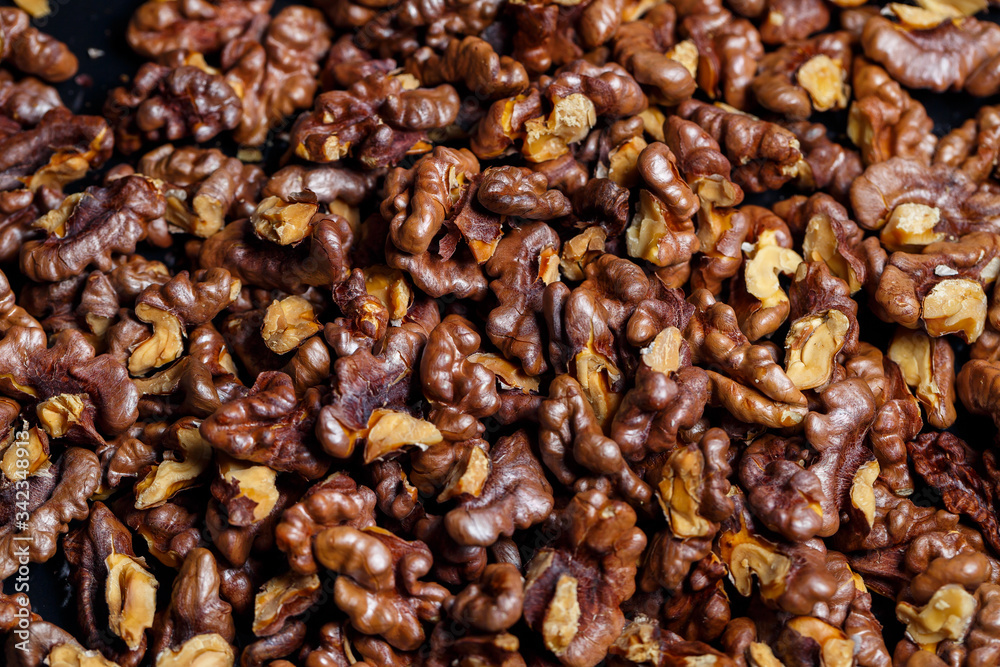 Roasted walnuts. Nuts help the brain work. Fatigue Food, Healthy Nuts. Superfood, vegan, vegetarian food concept. Macro of walnut texture, selective focus. Healthy snack. Roasted walnuts. Nuts help the brain work. Fatigue Food, Healthy Nuts. Superfood, vegan, vegetarian food concept. Macro of walnut texture, selective focus. Healthy snack.
