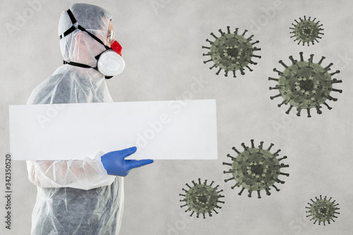 virologist in protective clothing holds advertising space in his hands