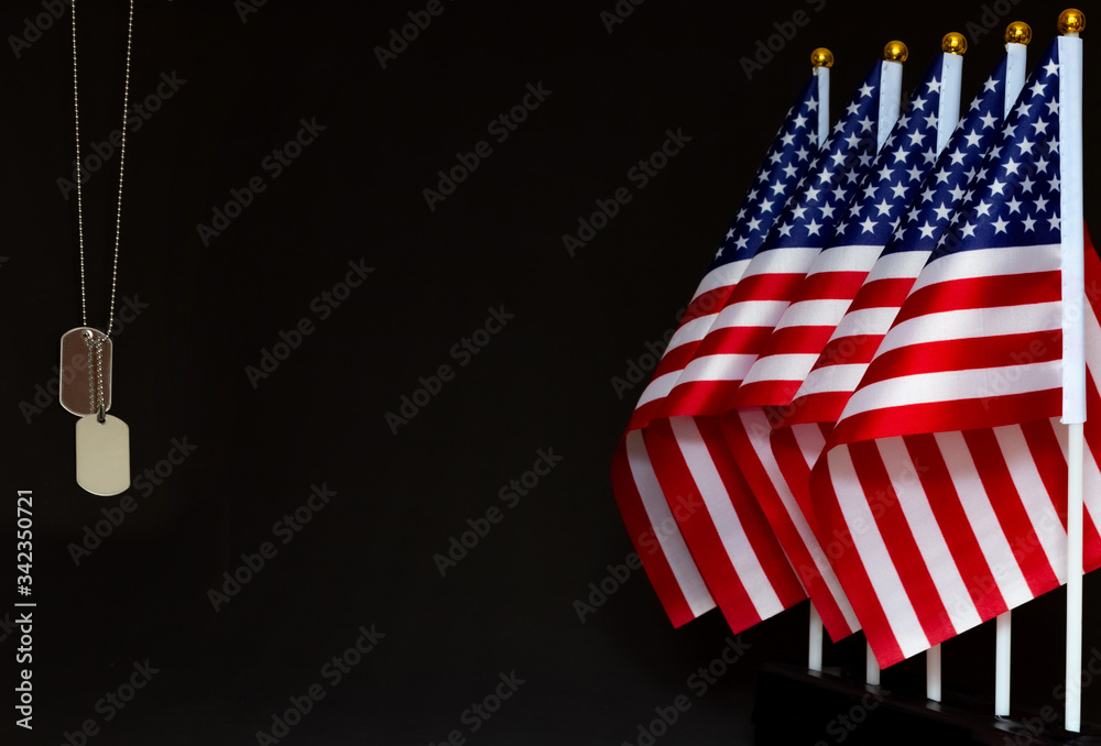 Desktop flags of USA and dog tags on black background with copy space ...