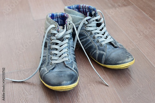 A pair of old school shoes with high ankle.