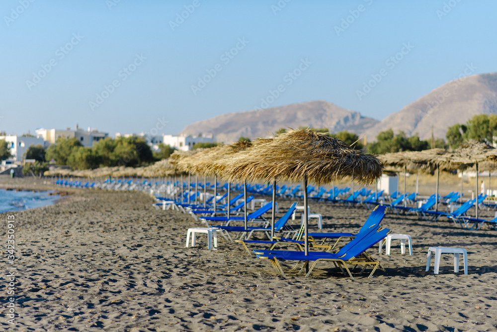 Empty deck chairs at Perissa beach. Santorini