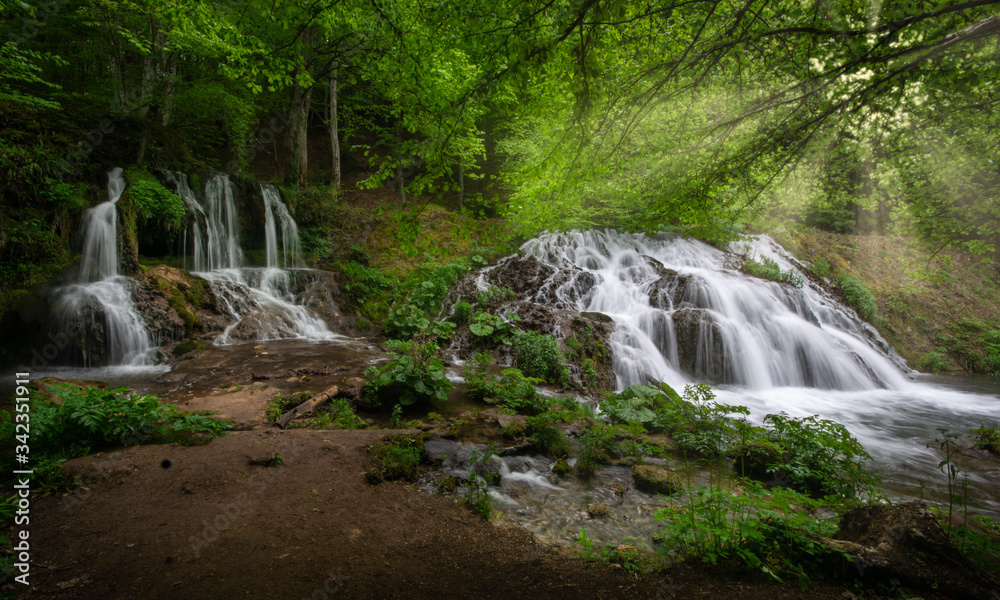 Waterfall in the forest. Beautiful waterfall Dokuzak in Strandzha Mountain, Bulgaria at spring. Green forest landscape near Bourgas Waterfall in the forest. Beautiful waterfall Dokuzak in Strandzha Mountain, Bulgaria at spring. Green forest landscape near Bourgas