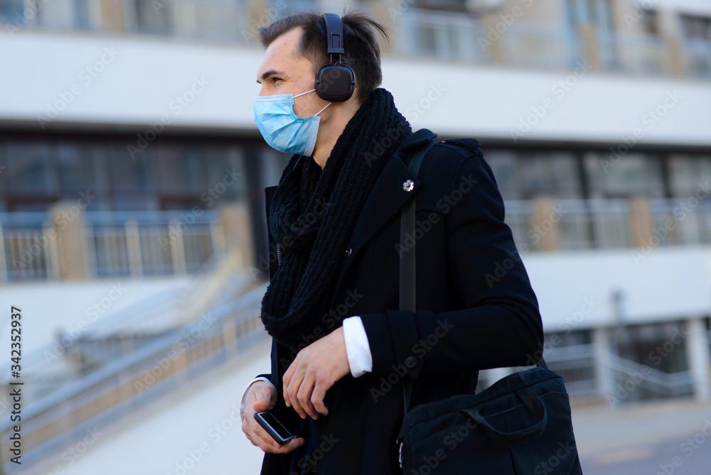 People with face mask. Concept with copy space. Portrait of adult man in quarantine of flu. Photo on the street in the city People with face mask. Concept with copy space. Portrait of adult man in quarantine of flu. Photo on the street in the city