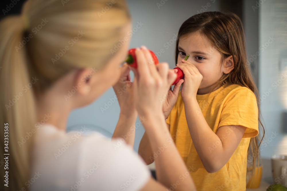 Teaching her daughter healthy eating habits. Teaching her daughter healthy eating habits.
