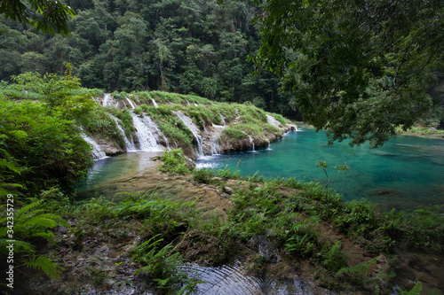 Paradise remote jungle waterfalls of semuc champey fresh turquoise clear water lush green rainforest photo