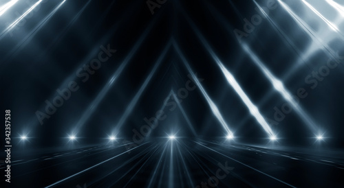 Dark empty abstract scene, rays of searchlights, neon blue light, highlights and lights. Night view of the scene, a tunnel with illumination. Dark background with spotlights.