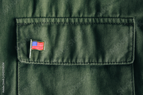 Fotografía USA flag pin badge on green jacket pocket