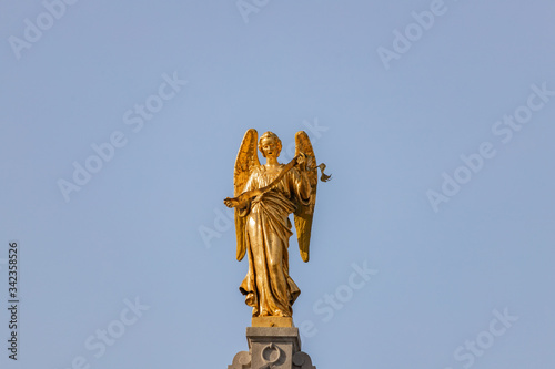 Gilded statue on top of Guildhouses view from Grand Market Square in Antwerp, Belgium photo