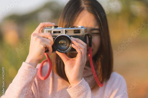 Asian travelling woman be smile with classic 35mm rangefinder film camera. Travel holiday concept