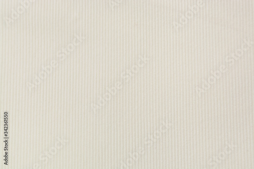 Corduroy background in close up. Texture of cream corduroy textile - useful as background photo