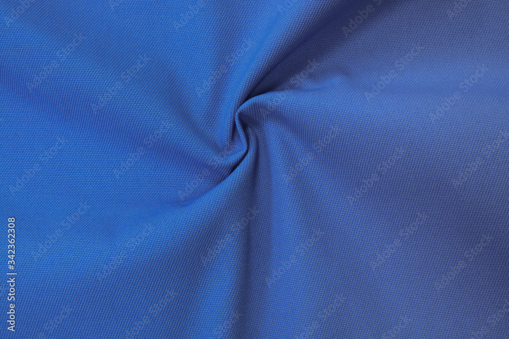 Blue dark monochrome cotton fabric. Closeup texture of the fabric is useful as a background. Blue dark monochrome cotton fabric. Closeup texture of the fabric is useful as a background.