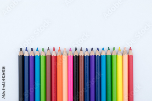 Colored pencils isolated in line on white background