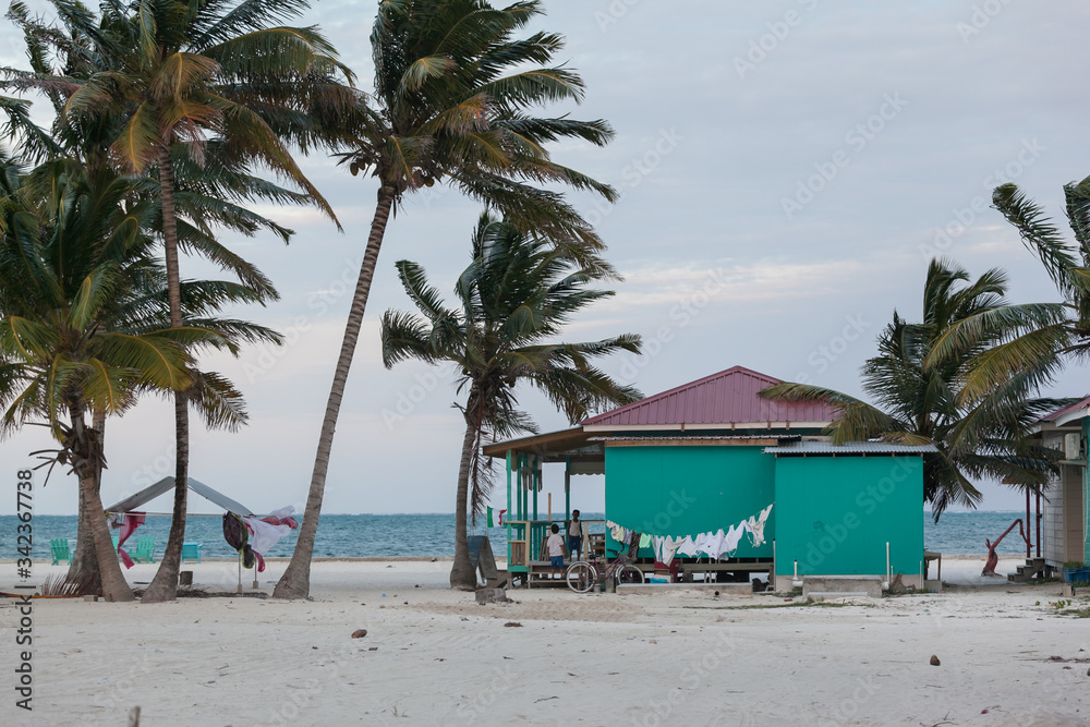  windy sunset on the paradise beach local wooden house. Caye Caulker, Belize