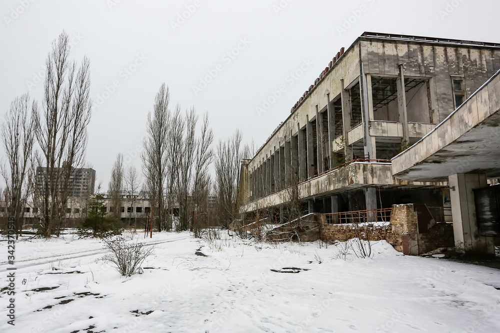 Abandoned ghost town Prypiat. Overgrown trees and collapsing buildings. Pripyat, Chornobyl exclusion zone. December 2016