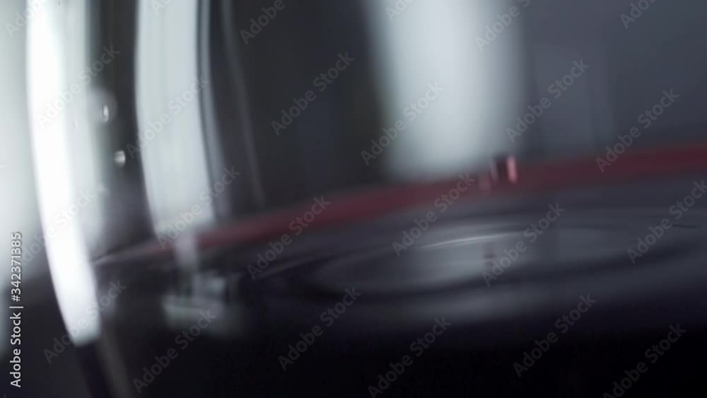 Slow motion red wine being poured into a glass