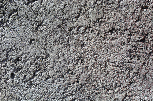 concrete background with large dents and stones