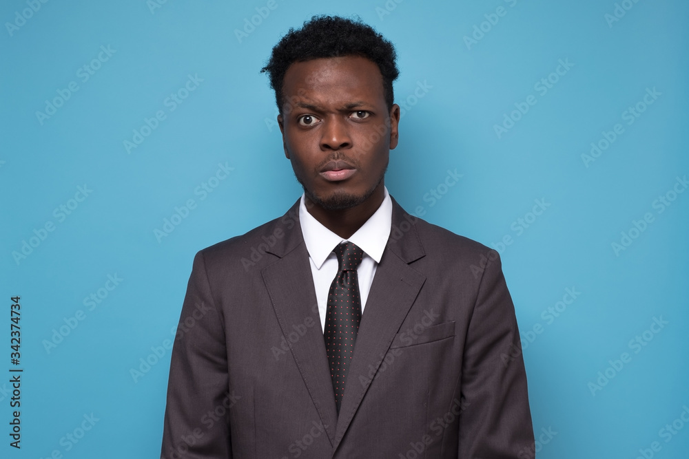 businessman in suit fronwing looking at camera seriously. businessman in suit fronwing looking at camera seriously.