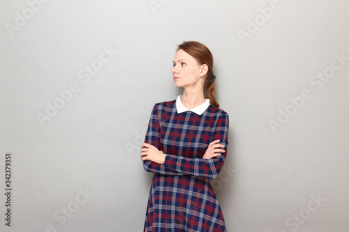 Obraz na płótnie Portrait of serious focused annoyed girl crossing arms over body