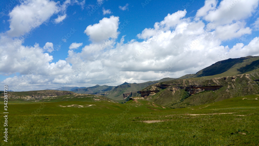 Fluffy clouds over rock formations in the Golden Gate Highlands National Park, Clarens, Free State, South Africa Fluffy clouds over rock formations in the Golden Gate Highlands National Park, Clarens, Free State, South Africa