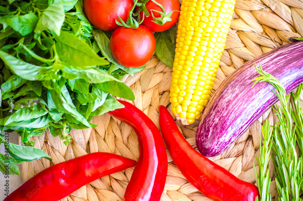 Raw vegetables close up. Top view of fresh tomatoes, basil, eggplant, red pepper and corn. Healthy eating concept, vegetable background. Selective focus image, flat lay. Raw vegetables close up. Top view of fresh tomatoes, basil, eggplant, red pepper and corn. Healthy eating concept, vegetable background. Selective focus image, flat lay.