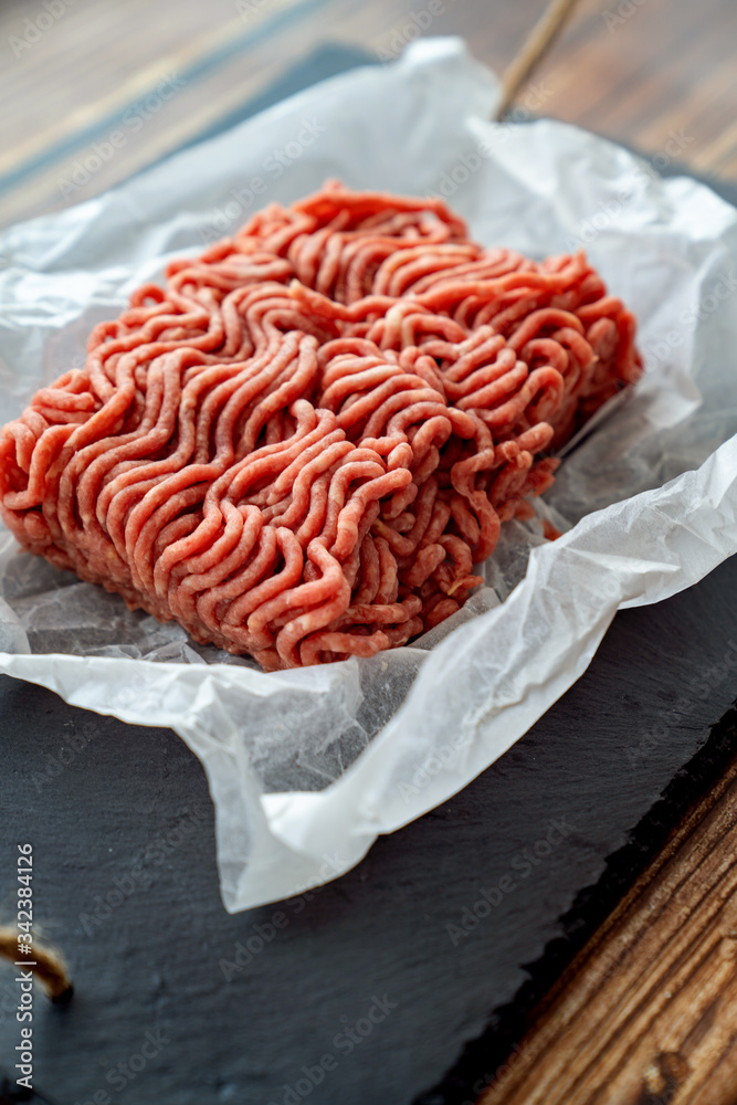 minced meat on cooking paper and stone tray minced meat on cooking paper and stone tray
