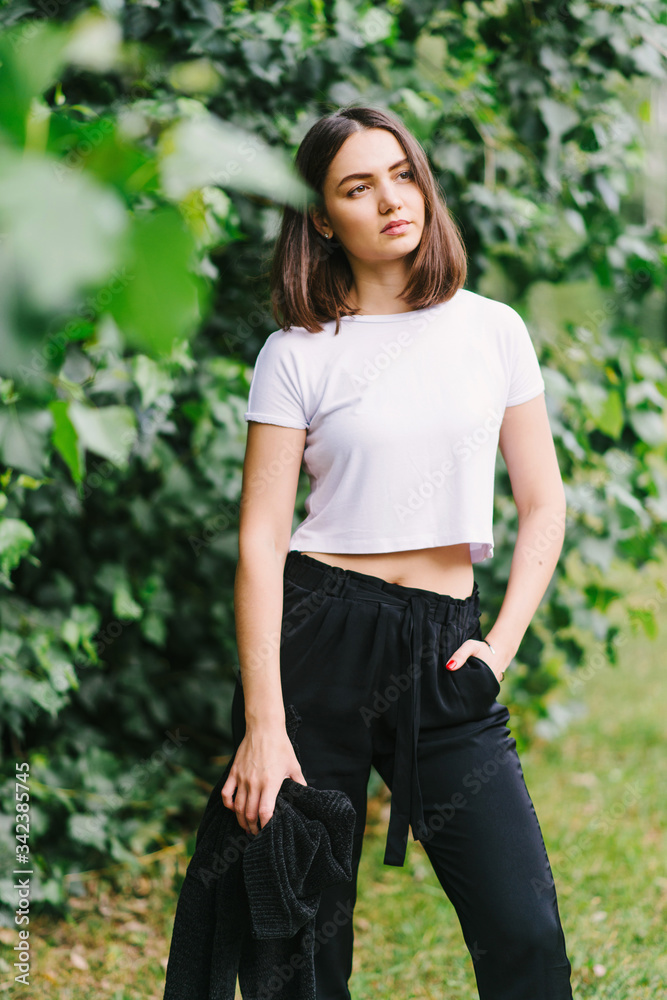 Stylish hipster girl in white t-shirt outdoors posing Stylish hipster girl in white t-shirt outdoors posing