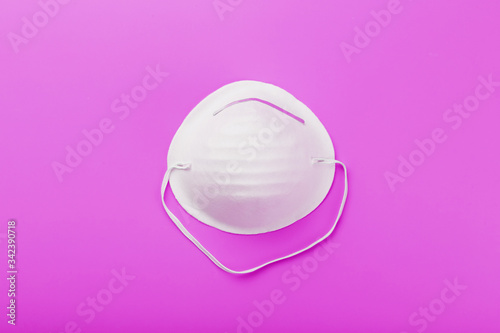 Round face mask on a pink background. Isolation of virus protection