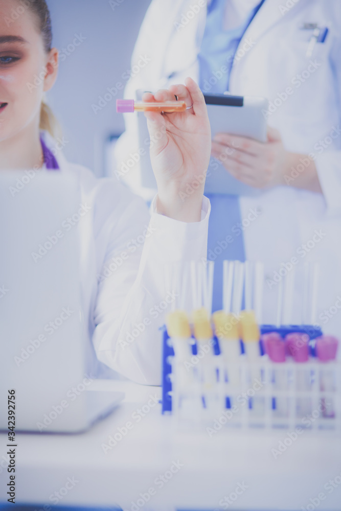 Laboratory assistant holding test tube. Laboratory assistant holding test tube.