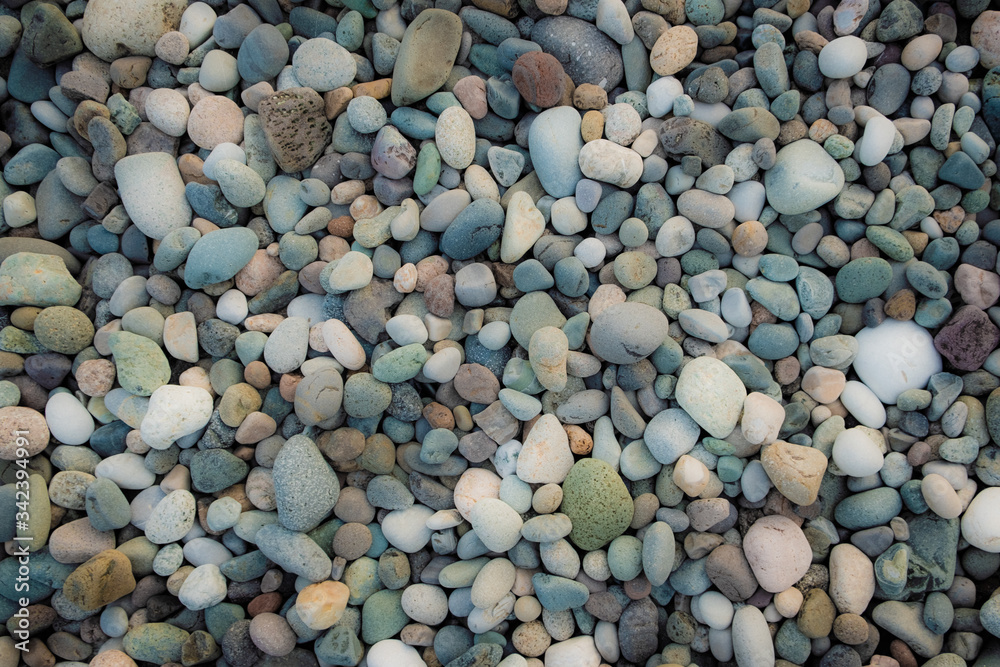 Background of sea pebbles. Abstract wallpaper of stones on the ocean. Multi-colored pebbles. Background of sea pebbles. Abstract wallpaper of stones on the ocean. Multi-colored pebbles.