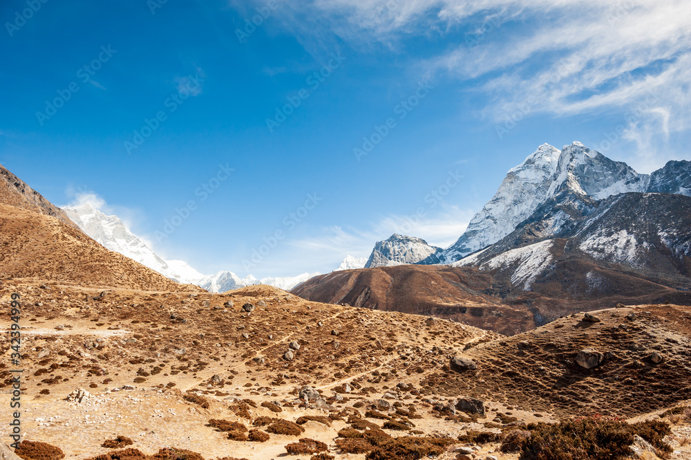 Valley leading to the Everest base camp with Cholatse and Taboche peak. Trekking in Nepal Himalayas. EBC (Everest base camp trek) trail upper part from Lukla to EBC of Everest trek. Nepal.