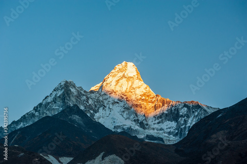 Sunrise on Ama Dablam peak mountain. Trekking in Nepal Himalayas. EBC (Everest base camp trek) trail upper part from Lukla to EBC of Everest trek. Nepal.