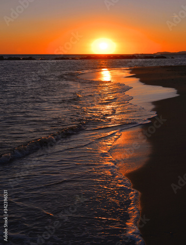 Orange Sunset Seascape with Mollarella sand beach (spiaggia di mollarella) near coastal city of Licata , SICILY Italy photo