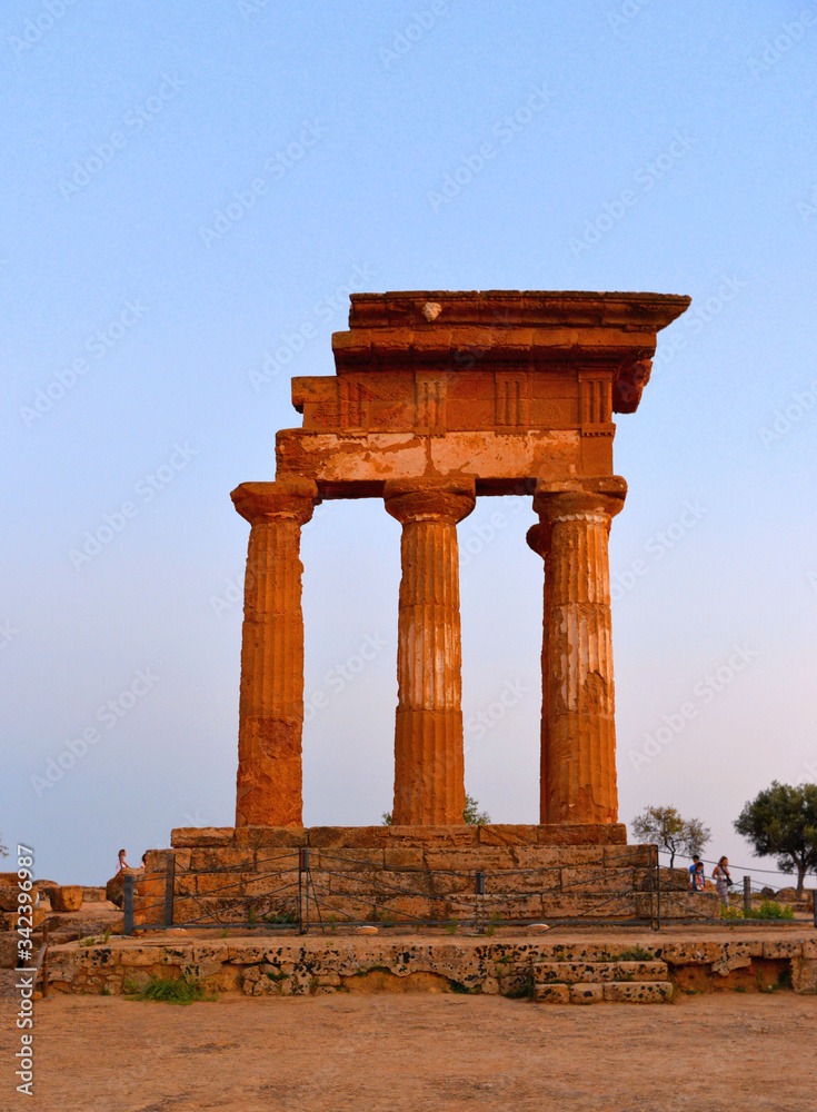 Ruined Temple of Heracles columns in famous ancient Valley of Temples on blue hour sunset in summer evening, Agrigento, Sicily, Italy. UNESCO World Heritage Site.