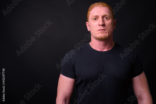 Portrait of muscular man with orange hair