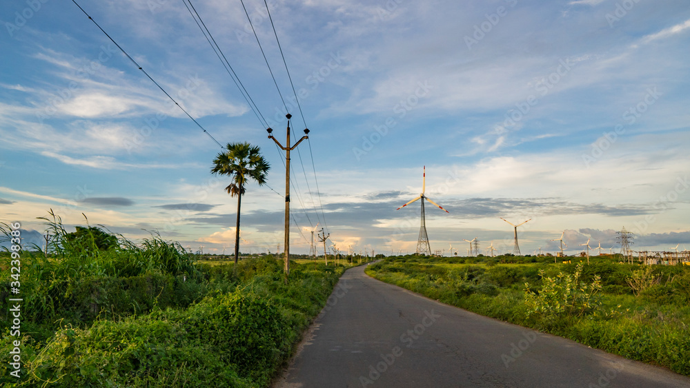 windmills for electric power production in the green field of wheat windmills for electric power production