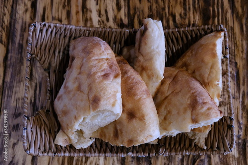 Pieces of pita bread in a basket on a table. Lavash is unleavened white bread in the form of a thin tortilla made of wheat flour, distributed mainly among the peoples of the Caucasus, Iran, Afghanista