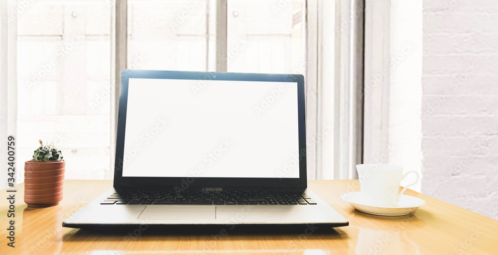 selective focus blank screen laptop,cactus and a cup of coffee on wooden table ,work online lifestyle relax at home selective focus blank screen laptop,cactus and a cup of coffee on wooden table ,work online lifestyle relax at home