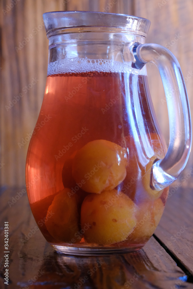 Georgian national cuisine. Georgian, homemade drink, compote in a jug. Drink on a wooden table. Georgian national cuisine. Georgian, homemade drink, compote in a jug. Drink on a wooden table.