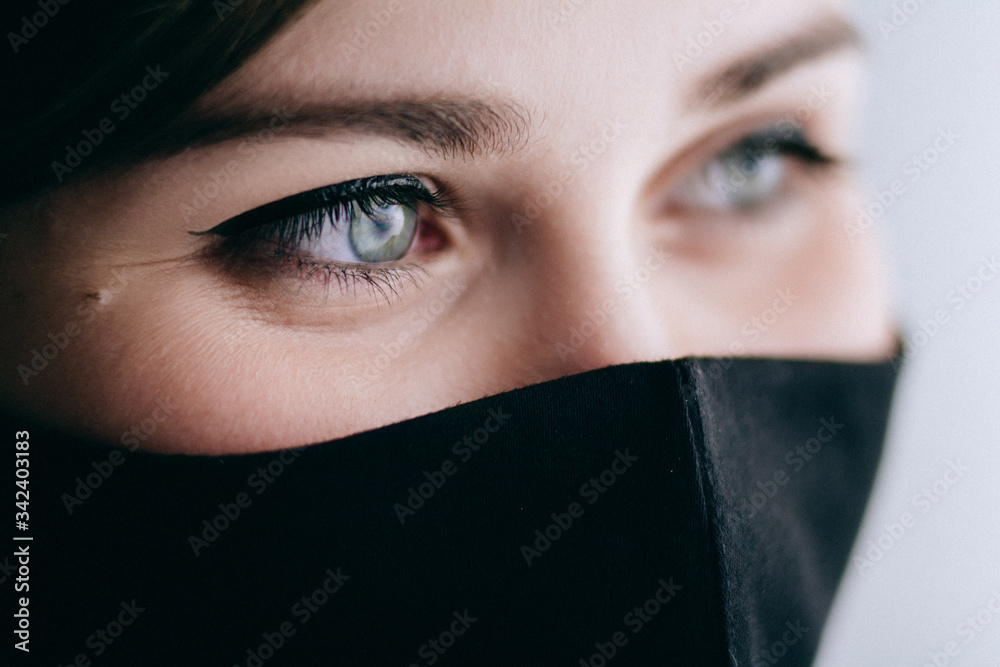 part of smiling face of a young beautiful woman in a black stylish mask, fashion and lifestyle 2020 under quarantine and epidemic, concept of science and positive looj future part of smiling face of a young beautiful woman in a black stylish mask, fashion and lifestyle 2020 under quarantine and epidemic, concept of science and positive looj future