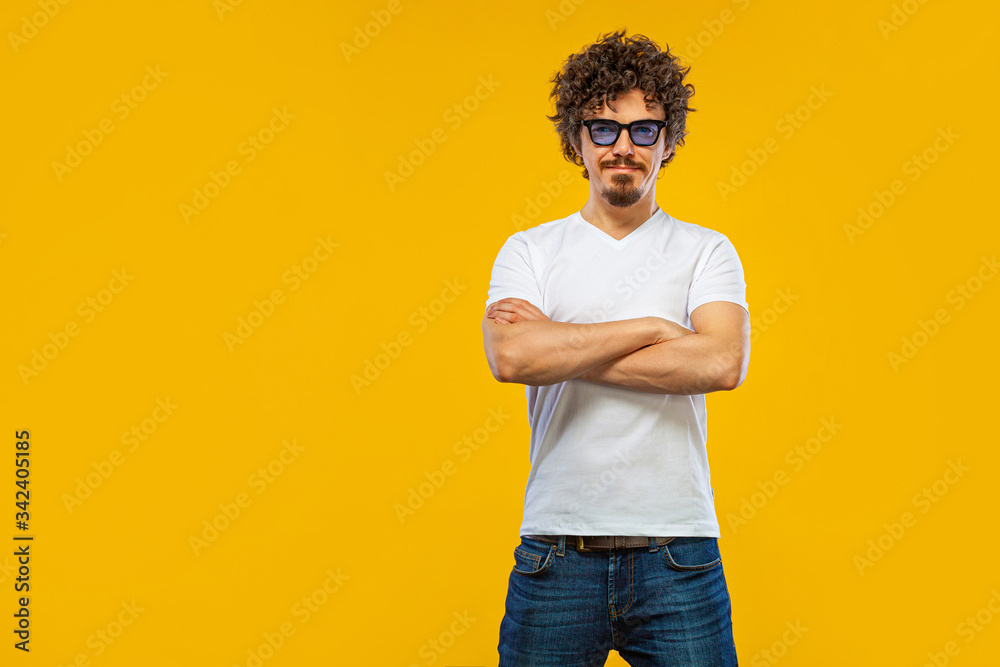 Handsome happy european man with beard in white t-shirt smiling isolated on yellow background. Lifestyle concept. Handsome happy european man with beard in white t-shirt smiling isolated on yellow background. Lifestyle concept.