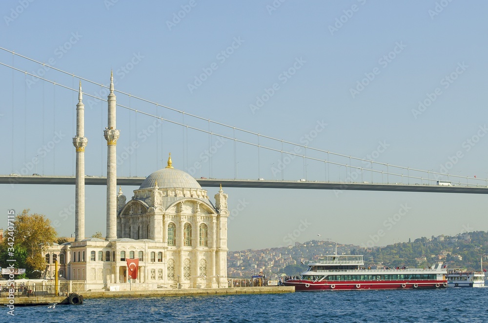 Bosphorus Bridge and Ortakoy Mosque against blue sky, situated at the waterside of Ortakoy pier square, one of the most popular locations on Bosphorus. Turkey, Istanbul, Besiktas