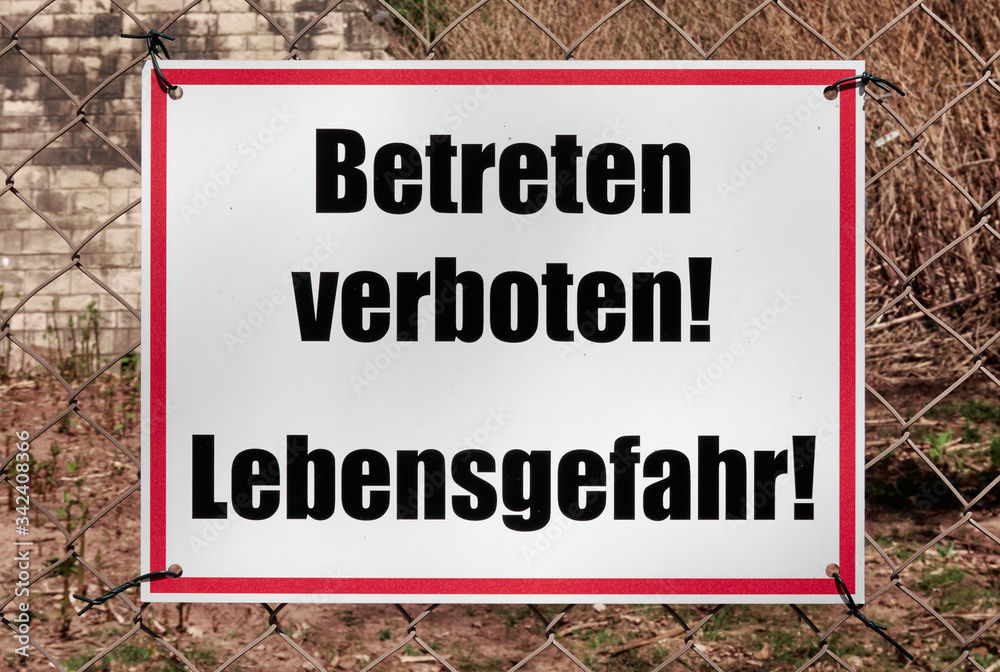 White shield with red frame and the inscription Do not enter! Danger to life! in German language White shield with red frame and the inscription Do not enter! Danger to life! in German language