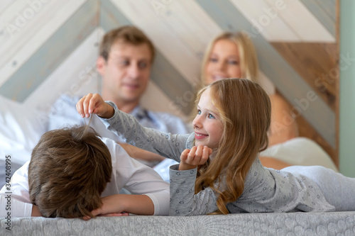 Father, mother, son and daughter in bedroom